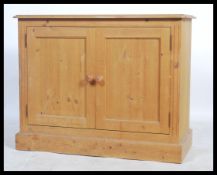 A good quality 20th century country pine school cupboard having double doors with shelved
