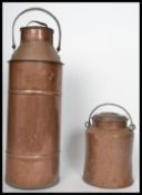 A large early 20th century agricultural copper and brass dairy milk churn with looped swing handle