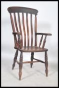 A good Victorian 19th century beech and elm wood windsor chair - armchair being raised on bulbous