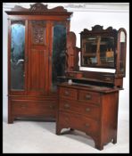 An Edwardian mahogany Art Nouveau wardrobe and dressing table bedroom suite. The wardrobe with