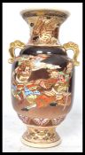 A 19th century Japanese Kutani vase having twin elephant handles. The body depicting fighting