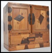 A believed 19th century specimin veneer Japanese table top scholars cabinet. The pedestal cabinet