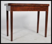 A 19th century Georgian mahogany and line border inlaid games - card table. Raised on square