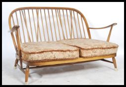 Ercol - A golden dawn Windsor two seater sofa / settee in beech and elm, having the propeller arm