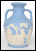 An early 20th century Edwardian Wedgwood small Portland vase, blue and white Jasper Ware with