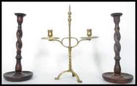 A group of three 19th century candlesticks to include a brass example raised on a tripod base with
