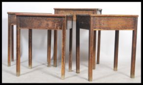 A set of four vintage early 20th century school desks, each with hinged slope enclosing storage,