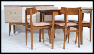 A retro mid century dining room suite comprising a sideboard, dining table and chairs. The