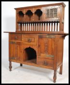 A 19th century Arts & Crafts oak sideboard dresser in the manner of Liberty & Co, London. The base