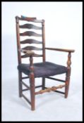 A 19th Georgian elm wood North Country carved armchair. The wavey ladder back armchair raised on