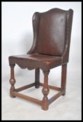 A 19th century Victorian leather wing back chair having a studded back with horse hair stuffed