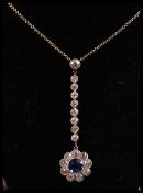 A vintage 18ct gold white gold, diamond and blue sapphire pendant necklace. The pendant consisting