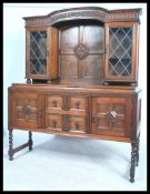 A 1920's oak barley twist dresser sideboard. The upright back with leaded glazed door cabinet over a