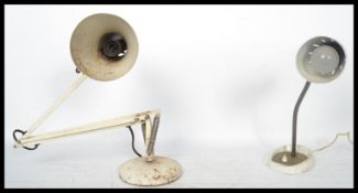 Two vintage 20th century retro industrial lamps one being a white mid century anglepoise and the