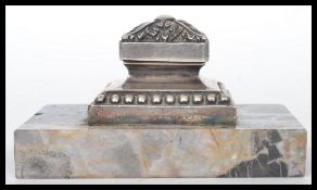 An early 20th century silver plated and marble paperweight. Raised on a rectangular marble base with