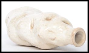 A 19th century ceramic flask in the form of a potato. Made as a mockery of the Irish potato