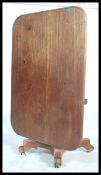 A 19th century mahogany rectangular tilt top  breakfast table on tapered floral carved stem and