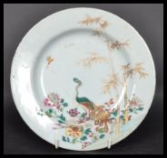 An 18th century Chinese Qing Long Famille Rose plate hand painted with enamels depicting floral