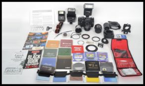 A vintage Zenit TTL camera together with lenses, flashes, extension tubes, filters etc all within