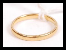 A hallmarked 22ct gold wedding band ring of typical form. Weighs 2.6 grams size K.