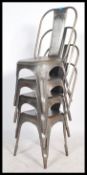 A set of four industrial Tolix style metal stacking cafe chairs. Each chair with a tapering splat