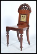 A late 19th century Victorian mahogany hall chair, inset with Minton tile to back rest, the tile