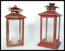 A pair of 20th century porch lantern lamps of square form having a painted red colour with four