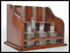 A stunning mid 20th century mahogany chemists fully appointed test tube stand with an arrangement of