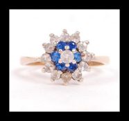 A hallmarked 9ct gold cluster ring set with blue and white stones. Hallmarked Birmingham. Weight 2.