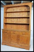 A good quality antique style pine welsh dresser. The base on plinth with a series of cupboards and