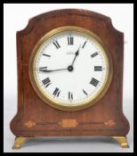 An early 20th century Edwardian mahogany mantel clock having box wood inlay. The white enamel dial