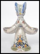 A Continental faience salt modelled as an 18th century double sided  lady with each side holding a