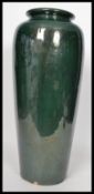 A vintage 20th century large floor standing pottery vase stick umbrella stand having a deep green