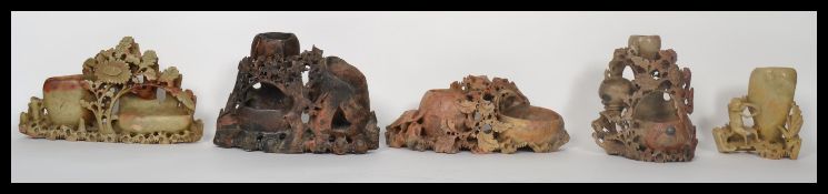 A collection of five 20th century Chinese soapstone brush pots, spill vase holders being carved