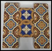 A group of eight 19th century Victorian ceramic encaustic floor tiles by Godwin tiles. Six