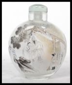 A 20th century Oriental Chinese glass perfume scent bottle depicting elders and a sweeping child