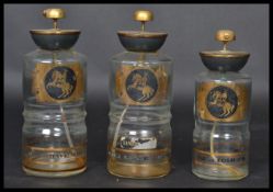 A set of three vintage glass and gilt metal aftershave / Cologne atomisers retaining  all applied