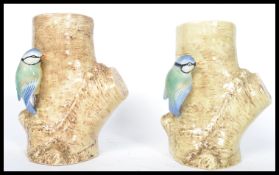 A pair of Sylvac pottery vases modelled with blue tits perched on a tree trunk, no 688, impressed