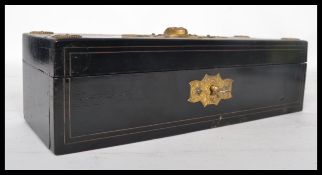 An early 20th century Egyptian belt buckle in the form of a winged scarab along with an Egyptian