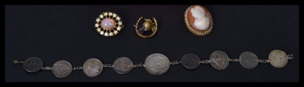 A group of vintage jewellery to include a 9ct gold ring , a silver ring, coin bracelet, cameo