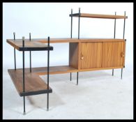 A vintage retro 20th century teak wood ladderax style corner shelving unit having a series of
