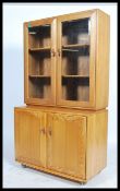 Ercol - Windsor - A retro beech and elm sideboard display cabinet comprising of a glazed twin door