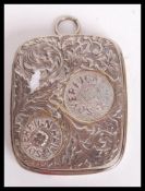 A 19th century Victorian silver plated sovereign coin holder having a scrolled design with bail loop