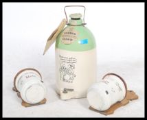 A stunning mid 20th century stoneware cider jar together with a pair of early 20th century wall