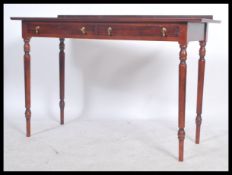 A Victorian style mahogany hall table - console writing table desk. Raised on turned legs with a