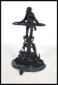 A 20th century cast metal stick stand in the manner of Coalbrookdale having an ebonsied finish