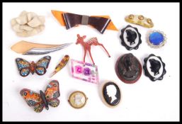 A collection of vintage and earlier brooches including Bakelite, Lucite, reversed carved, sculpted