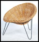 An original retro 20th century whicker tropics chair / armchair raised on a tripod hair pin leg