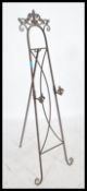 An oversized decorative scroll work folding easel picture / artists stand, having the ability to