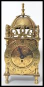 A Smiths Brass eight day XVII Century style lantern clock, bell with finial over a circular dial,